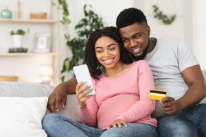 Couple looking at credit card and phone