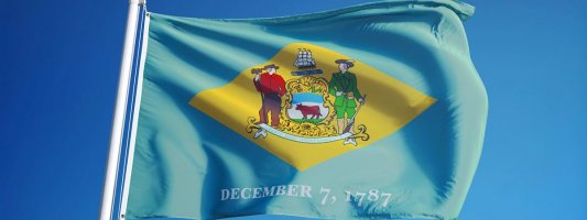 Delaware flag with blue sky background