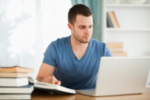man researching charge off online