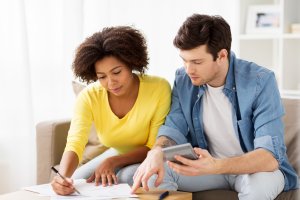Young couple at home with paper and calculator